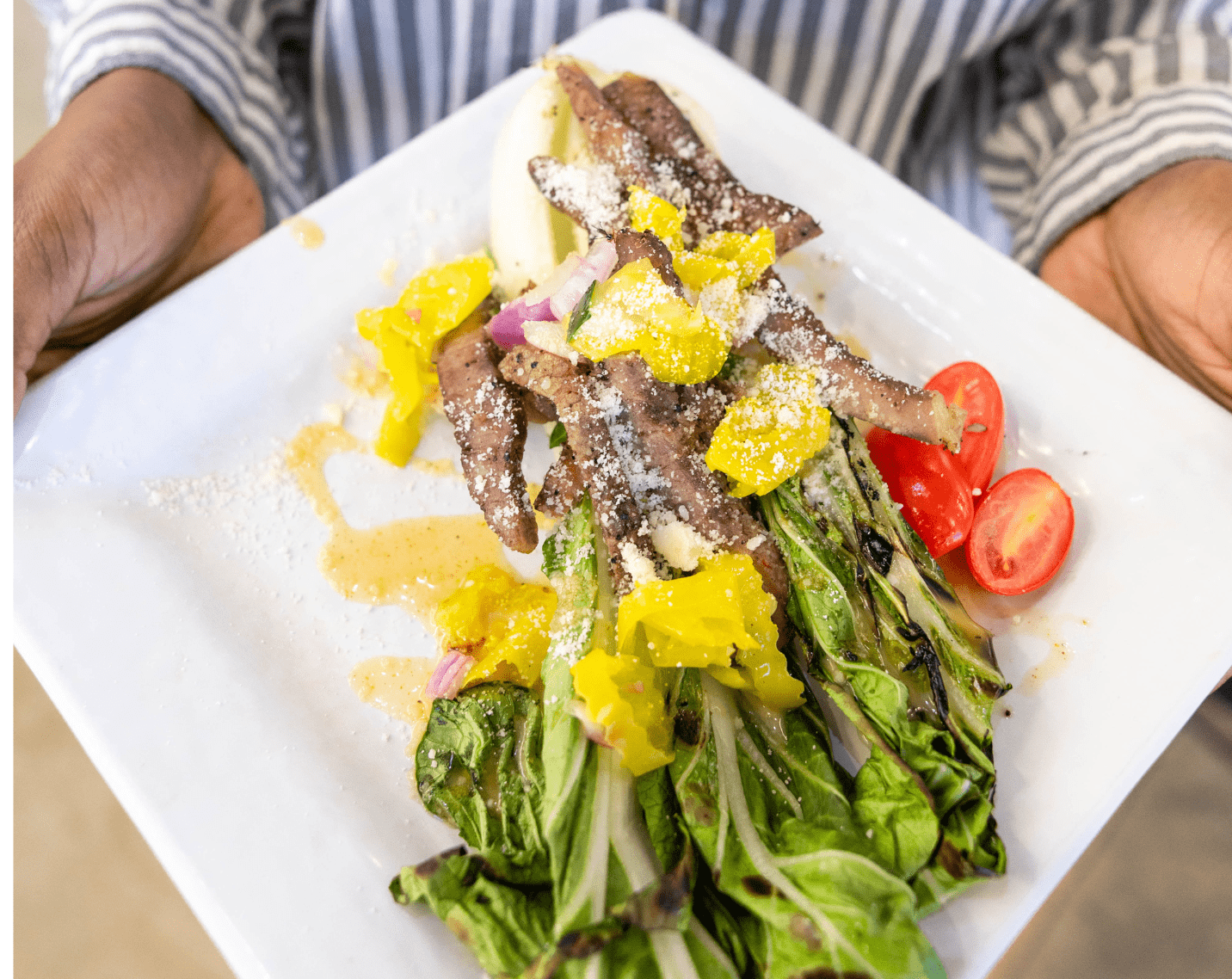 A plate with fresh vegetables and steak. 